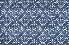 a blue fabric with white circles and leaves in the center, on top of a ruler