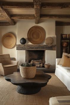 a living room with wicker furniture and baskets on the wall above the fire place