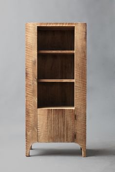 a wooden bookcase with three shelves on one side