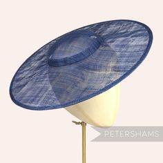 *This is not a fitted hat! You will need to attach a headband, comb or elastic to secure it to your head* This navy blue cartwheel hat base is a classic shape that has sprung into popularity in the past year. Made from 2 layers of stiffened sinamay, these cartwheels are ready to trim and are fitted with a petersham ribbon on the inside crown edge. Simply add a comb or headband to secure to the head. Hat base measures: Width: 35.5cm (14 inches) Crown Width: 13.5cm (5.3 inches) Crown Height: Appro Cartwheel Hat, Sinamay Fascinator, Blank Hats, Millinery Supplies, Hat Base, Crown Heights, Fascinator Hat, Millinery Hats, Fascinator Hats