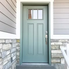 a green door on the side of a house