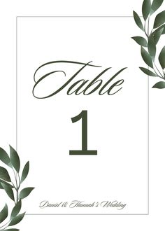 a table number with leaves on it and the word table 1 written in cursive writing