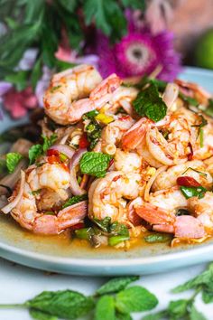 a white plate topped with shrimp and vegetables