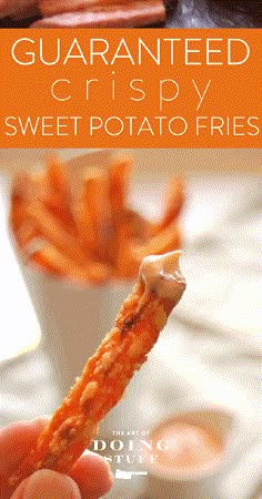 a hand holding a piece of sweet potato fries in front of some dipping sauce on the side