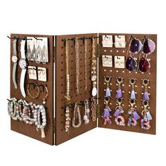 an open brown jewelry organizer with lots of earrings