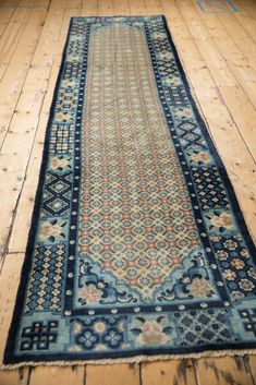 an old rug is laying on the floor in front of a wooden flooring area