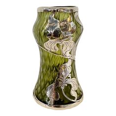 a green glass vase with flowers on it