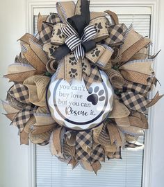 a dog's paw print wreath with the words you can't buy love but you can rescue it