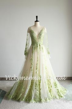 a green and white wedding dress on a mannequin