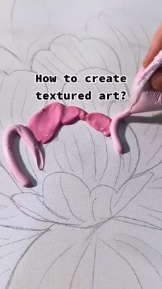 someone is using scissors to create an art project with pink and white paint on paper