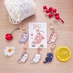 the keychains are decorated with cats and lemon slices