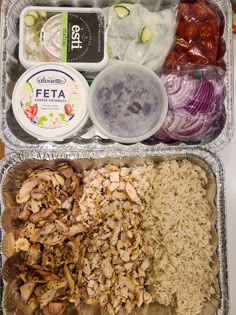 an open lunch box containing rice, meat and vegetables