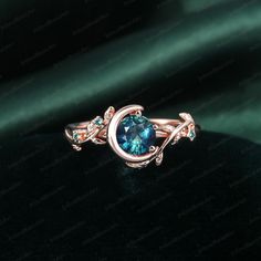 a ring with a blue stone in the center on a green velvet background, close up