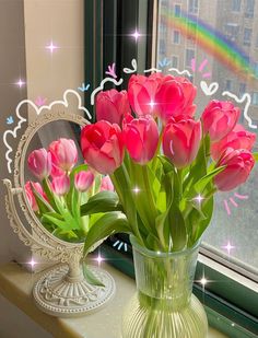 pink tulips are in a vase on a window sill near a mirror