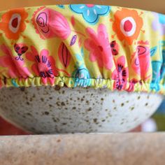 a close up of a bowl with flowers on it