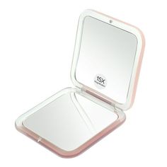 an open compact mirror with pink trim on the edges and bottom, in front of a white background