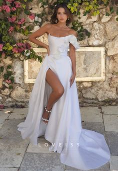 a woman in a white dress posing for the camera