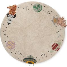 a round rug with various objects on it and stars in the sky, around which is a yellow toy car