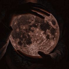 a person holding the moon in their hands