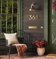 a chair sitting in front of a green door