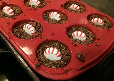 a red tray filled with cupcakes and candy canes