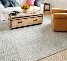 a living room filled with furniture and a table on top of a carpeted floor