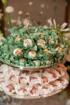 two tiered trays filled with green and white flowers