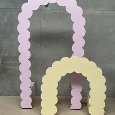 two pink and yellow archs sitting next to each other