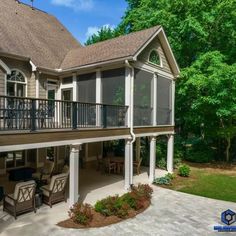 a large house with two balconies on the second floor and an attached deck