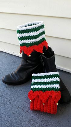 two pairs of black boots with red, green and white knitted booties