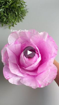 a person holding a large pink flower in their hand with the words easy crafts on it