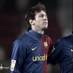 two soccer players standing next to each other