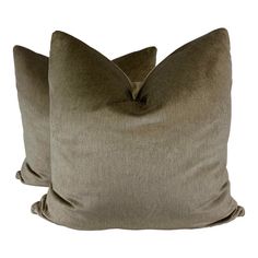 two brown pillows sitting next to each other