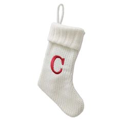 a white christmas stocking with the letter c on it