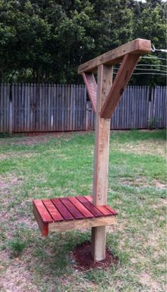 a wooden bench sitting in the middle of a yard