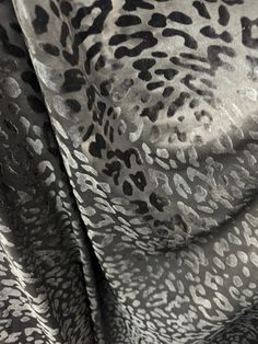 an animal print fabric with black and white spots