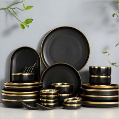 black and gold dinnerware set with green leaves