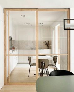 an open kitchen and dining room with sliding glass doors