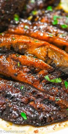 grilled meat with sauce and herbs on a plate