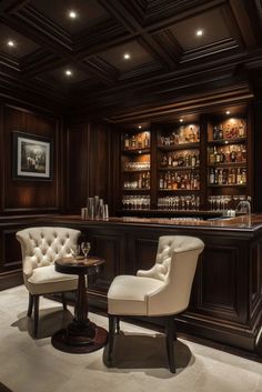 an elegant home bar with two chairs and a wine glass on the table in front of it