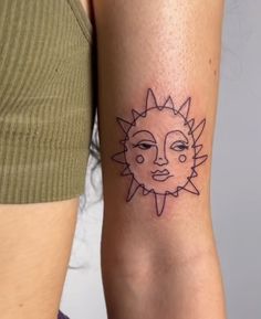 a woman with a sun tattoo on her arm