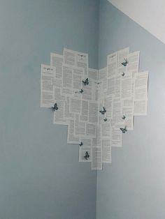 several pieces of paper are hanging on the wall above a toilet in a room with blue walls