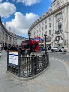 a red double decker bus driving down a street