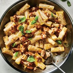 a bowl filled with pasta and meat sauce