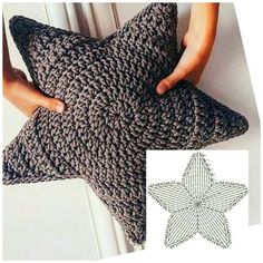 a person holding up a crocheted star pillow