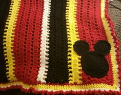 a crocheted blanket with a mickey mouse on it