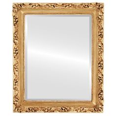 a gold framed mirror on a white wall