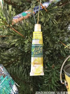 an ornament hanging from a christmas tree next to a potted pine branch