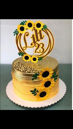 a cake decorated with sunflowers and the words lite 23 on it's top