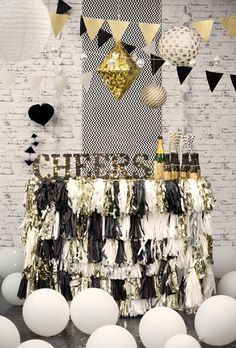 a black and white party table with balloons